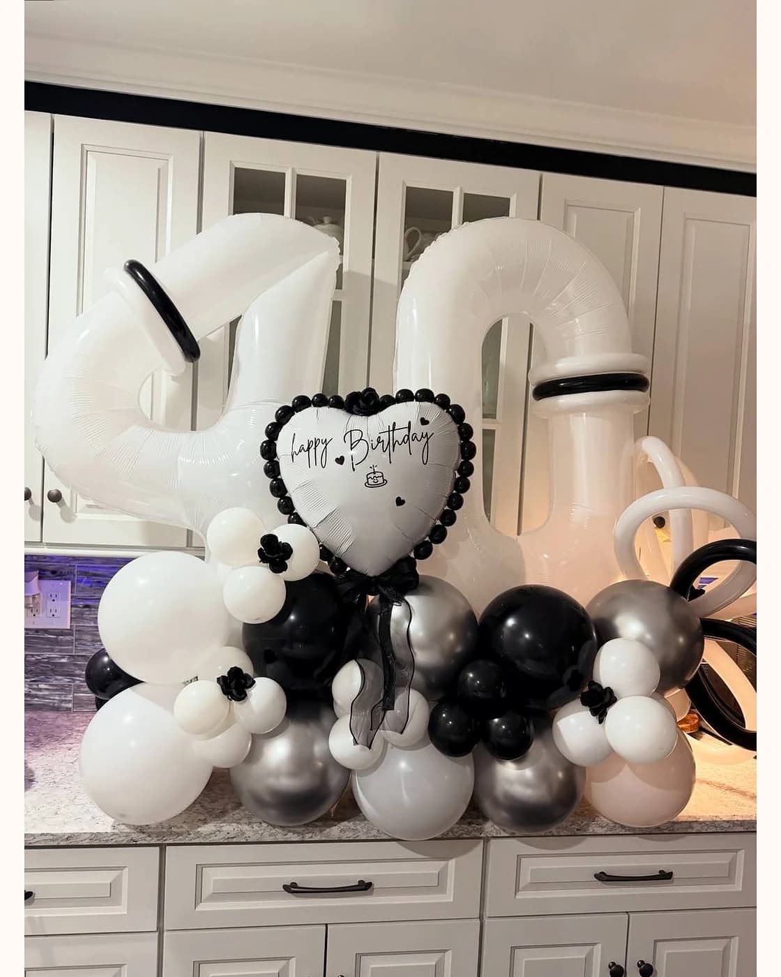 Black, white, and silver balloon bouquet for a 40th birthday celebration