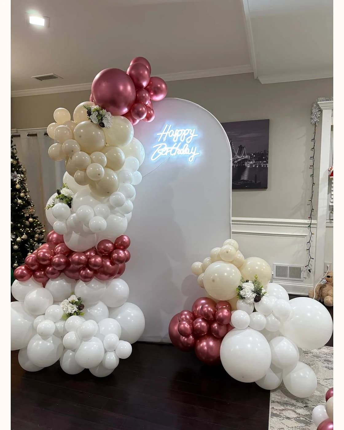 Ivory and rose-gold birthday backdrop with floral details and a happy birthday sign