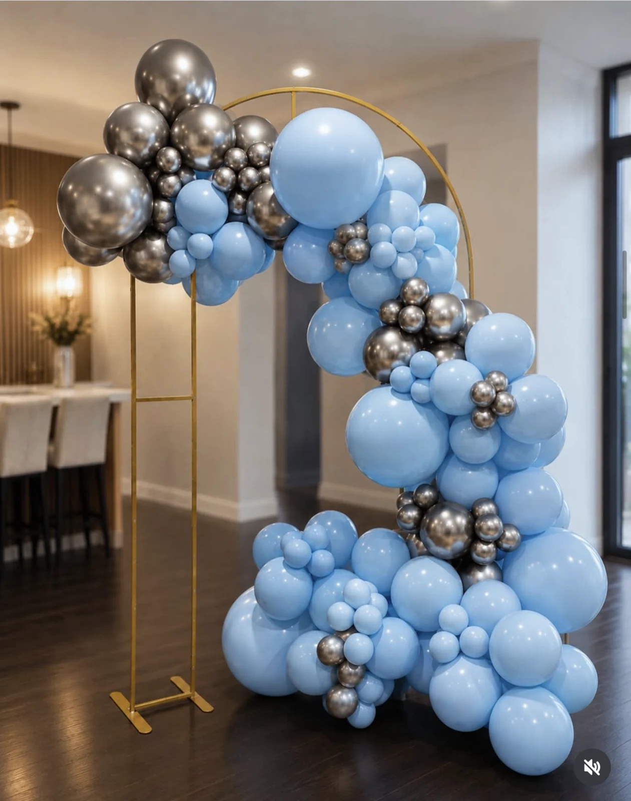 Blue, silver, and charcoal balloon arrangement on a gold circle stand