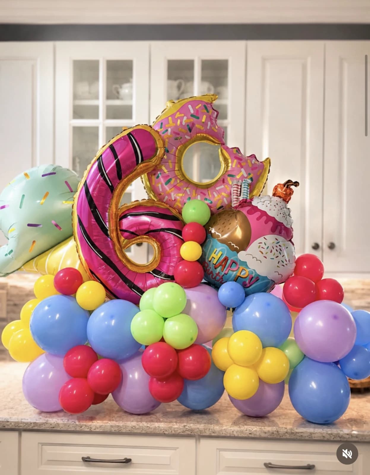 Colorful donut-themed balloon sculpture with a large number six