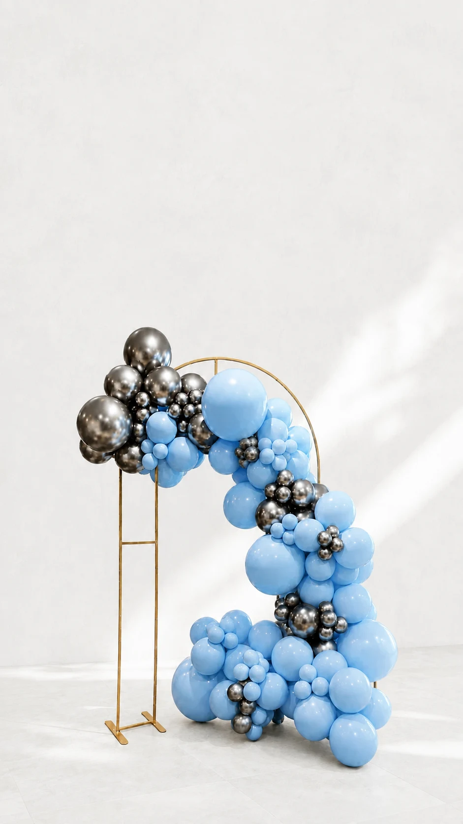 Blue and silver balloon arch on a gold frame